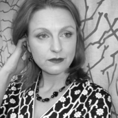 Black and white portrait photo of the author, Elle Brooker taken by photographer T. Donald